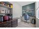 Dedicated home office area featuring a built-in desk, shelving, and contemporary decor at 11024 Purple Martin Blvd, Riverview, FL 33579