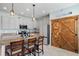 Charming kitchen featuring a granite island with seating, modern appliances, and wood-accented pantry at 11024 Purple Martin Blvd, Riverview, FL 33579