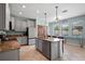 Well-lit kitchen with granite counters, island bar seating, and a view of the pool through a window at 11024 Purple Martin Blvd, Riverview, FL 33579