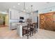 Stylish kitchen boasts a granite island with seating, modern appliances, and wood-accented pantry doors at 11024 Purple Martin Blvd, Riverview, FL 33579