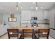 Bright kitchen showcasing a granite island with bar seating, modern appliances, and ample cabinet space at 11024 Purple Martin Blvd, Riverview, FL 33579