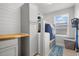 Bright laundry room with built in cabinets, folding counter and appliances at 11024 Purple Martin Blvd, Riverview, FL 33579