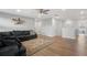 Bright and airy living room boasts wood floors, a ceiling fan and stairway access at 11024 Purple Martin Blvd, Riverview, FL 33579