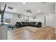 Spacious living room with hardwood floors, ceiling fan and a large comfy couch at 11024 Purple Martin Blvd, Riverview, FL 33579