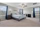 Comfortable main bedroom features a shiplap accent wall, ceiling fan, and neutral carpet at 11024 Purple Martin Blvd, Riverview, FL 33579