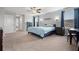 Relaxing main bedroom with ship lap accent wall, ceiling fan and a large window at 11024 Purple Martin Blvd, Riverview, FL 33579