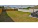 Large backyard with fencing, lawn, and patio dining set at 11438 Ivy Flower Loop, Riverview, FL 33578
