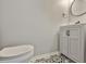 Stylish half-bathroom featuring a modern vanity and black and white patterned flooring for a chic look at 11438 Ivy Flower Loop, Riverview, FL 33578