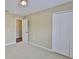 This bedroom has carpet and double doors to a closet at 11438 Ivy Flower Loop, Riverview, FL 33578