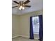 This bedroom has blue curtains on the windows and a ceiling fan at 11438 Ivy Flower Loop, Riverview, FL 33578