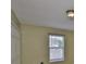 A tan bedroom features a window with white blinds at 11438 Ivy Flower Loop, Riverview, FL 33578