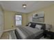 This bedroom features neutral walls, carpet, and a large window at 11438 Ivy Flower Loop, Riverview, FL 33578