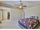 Spacious bedroom boasts a ceiling fan and an open walkway to a walk-in closet at 11438 Ivy Flower Loop, Riverview, FL 33578