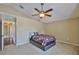 Cozy bedroom featuring a ceiling fan, neutral walls, and carpet flooring at 11438 Ivy Flower Loop, Riverview, FL 33578