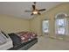 Bedroom with a ceiling fan, carpet floors, and two windows for natural light at 11438 Ivy Flower Loop, Riverview, FL 33578
