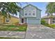 Charming light blue two-story home with a well-manicured lawn and an attached two-car garage at 11438 Ivy Flower Loop, Riverview, FL 33578
