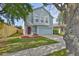 Charming light blue two-story home with a well-manicured lawn and an attached two-car garage at 11438 Ivy Flower Loop, Riverview, FL 33578