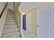 Hallway with staircase and closet provides access to upper levels of the home, bathed in natural light at 11438 Ivy Flower Loop, Riverview, FL 33578