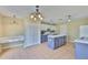 Spacious kitchen features an island, white appliances, ample cabinet space, and modern lighting at 11438 Ivy Flower Loop, Riverview, FL 33578