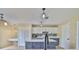 Modern kitchen with white cabinets, gray base cabinets, and a spacious island, perfect for meal preparation at 11438 Ivy Flower Loop, Riverview, FL 33578