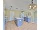 Spacious kitchen featuring gray base cabinets and island, modern appliances, and ample counter space at 11438 Ivy Flower Loop, Riverview, FL 33578