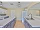 Kitchen features white appliances, ample counter space, a double sink, and neutral wall paint at 11438 Ivy Flower Loop, Riverview, FL 33578