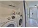 Bright laundry area with a side-by-side washer and dryer for convenient chore completion at 11438 Ivy Flower Loop, Riverview, FL 33578
