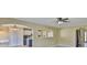 Bright living room boasts arched doorways and neutral paint, seamlessly connecting to other areas of the home at 11438 Ivy Flower Loop, Riverview, FL 33578