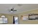 Bright and airy living space with a window, an archway, and a ceiling fan with a light fixture at 11438 Ivy Flower Loop, Riverview, FL 33578