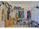 Organized walk-in closet with ample storage for clothing and shoes, shelving and hanging racks at 11438 Ivy Flower Loop, Riverview, FL 33578