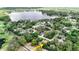 Aerial view of property in neighborhood near a beautiful lake, indicated by an arrow at 11945 Darwin Ave, New Port Richey, FL 34654