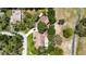 High angle view of a house with a pool, lush greenery, and a spacious driveway at 11945 Darwin Ave, New Port Richey, FL 34654