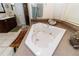Bathroom with a relaxing, tiled corner jacuzzi tub, separate glass shower, and dark wood vanity at 11945 Darwin Ave, New Port Richey, FL 34654