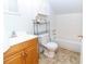 Classic bathroom with bathtub, wood vanity, and overhead storage cabinet for essentials at 11945 Darwin Ave, New Port Richey, FL 34654