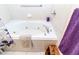 Enjoy a relaxing soak in this white jacuzzi bathtub with chrome fixtures and white tile surround at 11945 Darwin Ave, New Port Richey, FL 34654