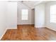 Bright bedroom features wood-look flooring, neutral walls, and vaulted ceiling at 11945 Darwin Ave, New Port Richey, FL 34654
