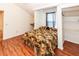 Cozy bedroom featuring built-in desk, wood floors, and natural light from two windows at 11945 Darwin Ave, New Port Richey, FL 34654