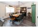 Traditional dining room with stylish velvet chairs, hardwood floors, and a modern light fixture at 11945 Darwin Ave, New Port Richey, FL 34654