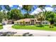 Charming single-story home with well-manicured lawn, palm trees, and a spacious driveway at 11945 Darwin Ave, New Port Richey, FL 34654
