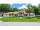 Charming single-story home with manicured lawn and mature landscaping, plus double front doors at 11945 Darwin Ave, New Port Richey, FL 34654