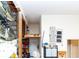 Well-organized garage space with overhead storage and a ladder at 11945 Darwin Ave, New Port Richey, FL 34654