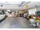 Spacious two car garage with ample storage space, workbench, shelving, and a white car at 11945 Darwin Ave, New Port Richey, FL 34654