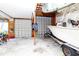 Well-lit garage featuring large overhead doors and parking for watercraft at 11945 Darwin Ave, New Port Richey, FL 34654