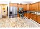 Bright kitchen showcasing stainless steel appliances, wooden cabinets and granite countertops at 11945 Darwin Ave, New Port Richey, FL 34654