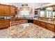 Kitchen featuring wooden cabinetry, granite countertops and stainless steel appliances at 11945 Darwin Ave, New Port Richey, FL 34654