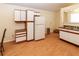 Bright kitchen features white cabinets and modern flooring at 11945 Darwin Ave, New Port Richey, FL 34654