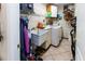 Functional laundry room with a utility sink, washer, dryer, and storage shelves for household tasks at 11945 Darwin Ave, New Port Richey, FL 34654