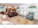 Open-concept living room features hardwood floors, comfortable seating, and french doors that leads to the backyard at 11945 Darwin Ave, New Port Richey, FL 34654