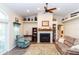 Inviting living room with vaulted ceilings, fireplace, ceiling fan, and hardwood flooring at 11945 Darwin Ave, New Port Richey, FL 34654
