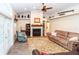 Living room area featuring a fireplace, vaulted ceilings, ceiling fan, and hardwood flooring at 11945 Darwin Ave, New Port Richey, FL 34654